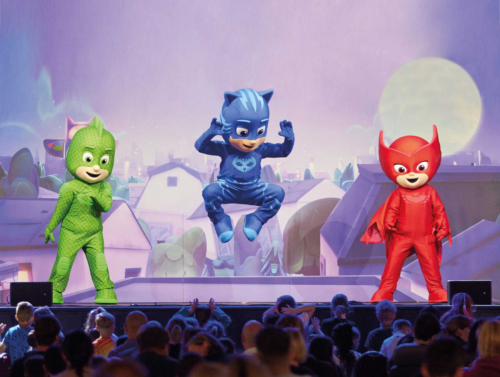 Three mascots of the members of PJ Masks performing on stage.