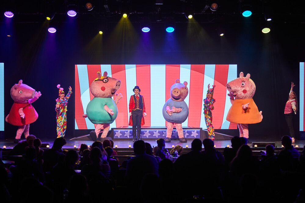 Peppa Pig and family stand on stage for the Peppa's Circus Celebration show.