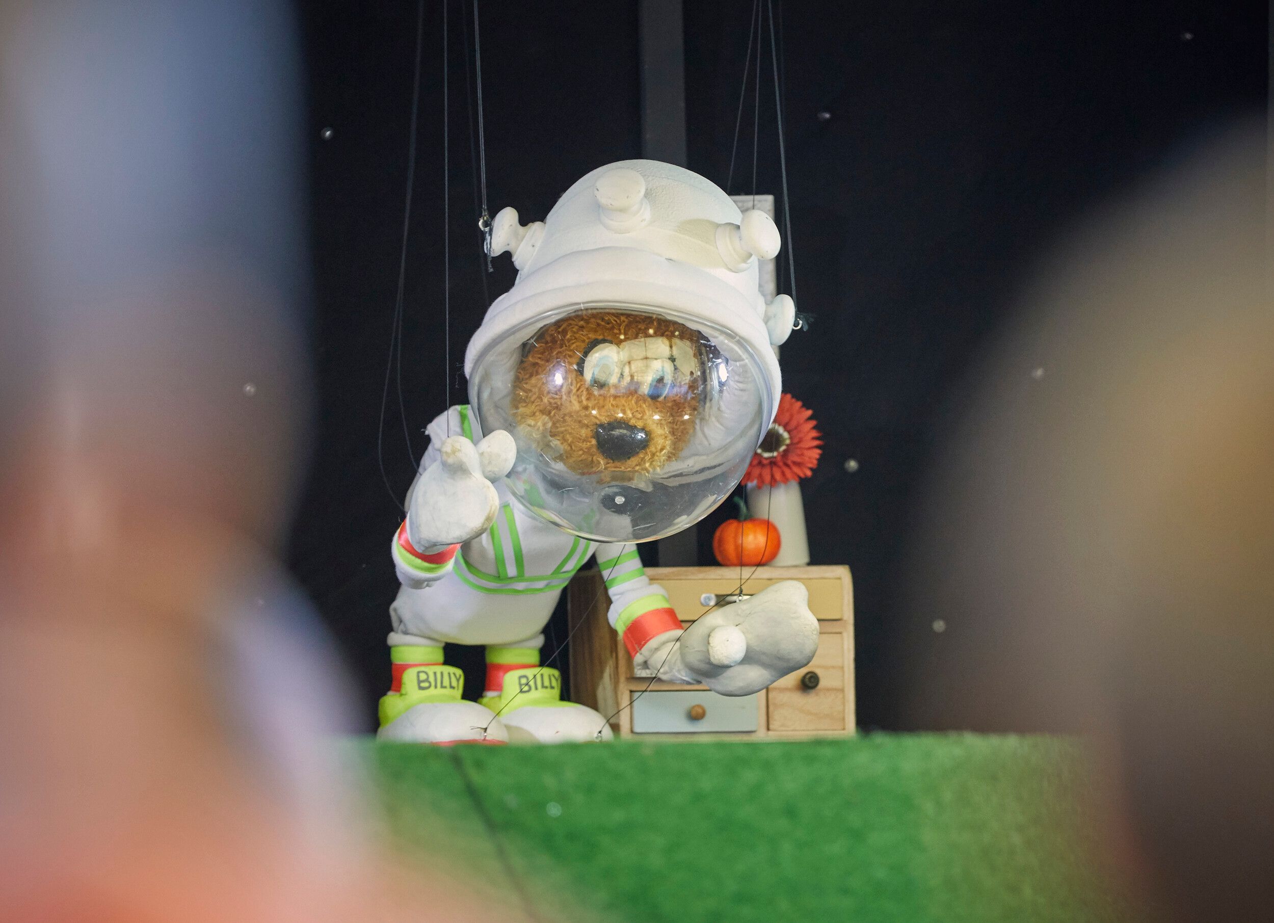 A puppet of Billy Bear in an astronaut costume on stage.