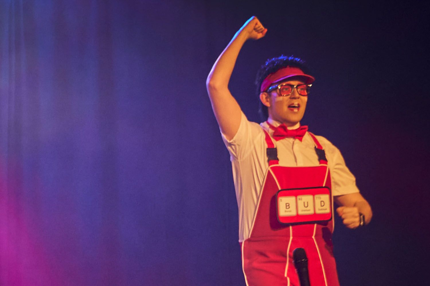 Bud, a member of Skyline Gang, wearing a red attire while performing on stage.