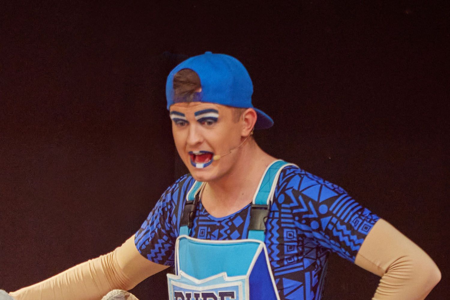 Dude, a member of Skyline Gang, wearing a blue attire while performing on stage.