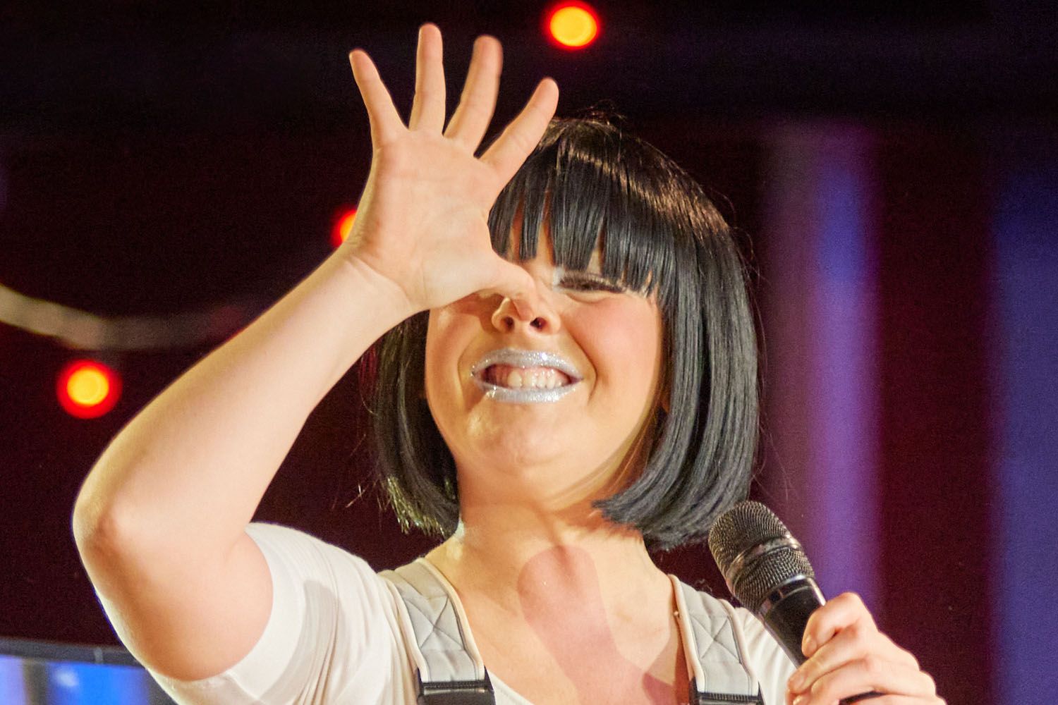 Misty, a member of Skyline Gang, wearing a grey attire while performing on stage.