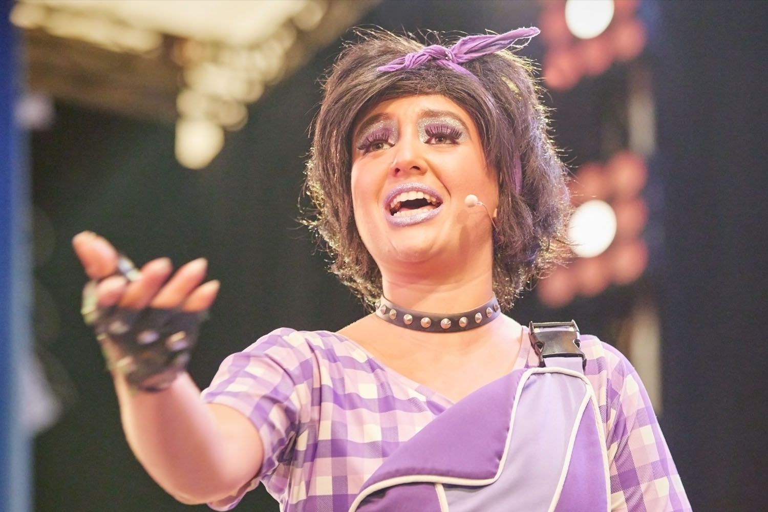 Pip, a member of Skyline Gang, wearing a purple attire while performing on stage.