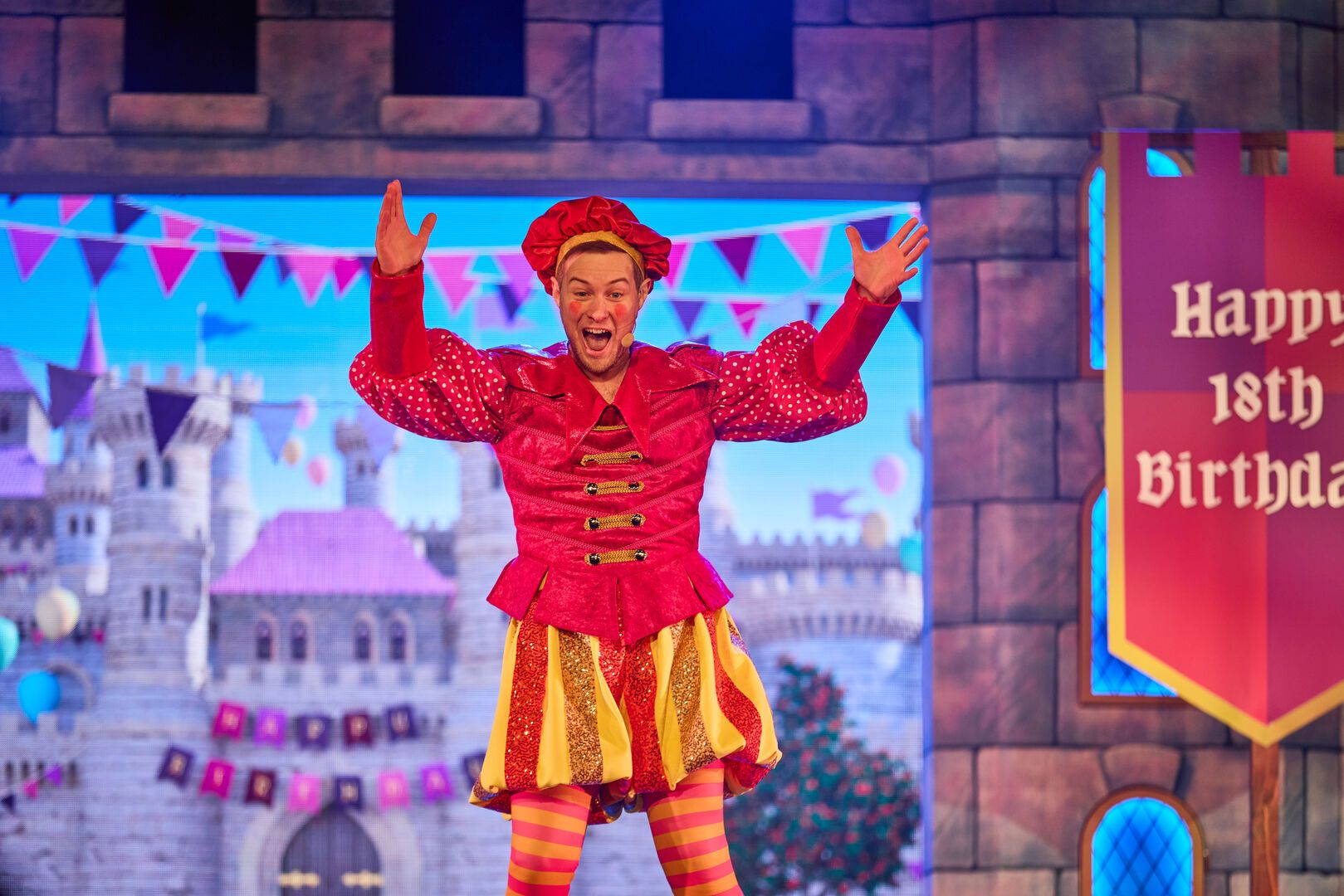 A performer gestures to the audience while performing in Snow White and her Magnificent Friends panto at Butlin's.