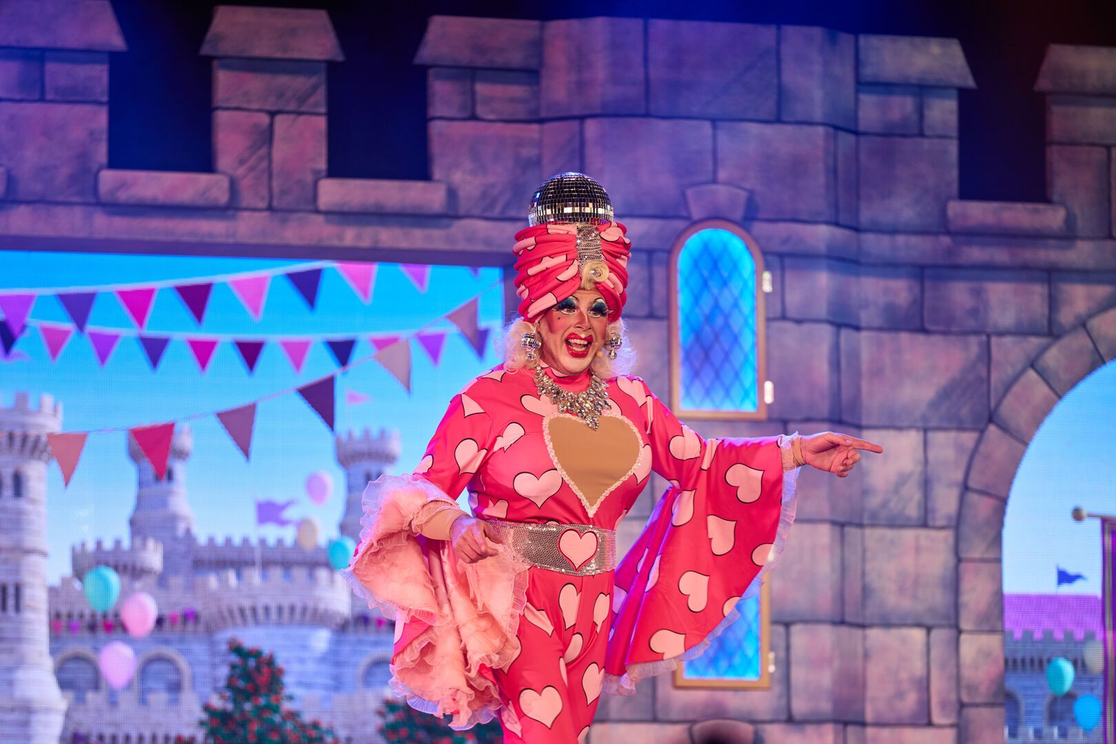 A performer on stage for the Snow White and her Magnificent Friends panto show at Butlin's address the audience.
