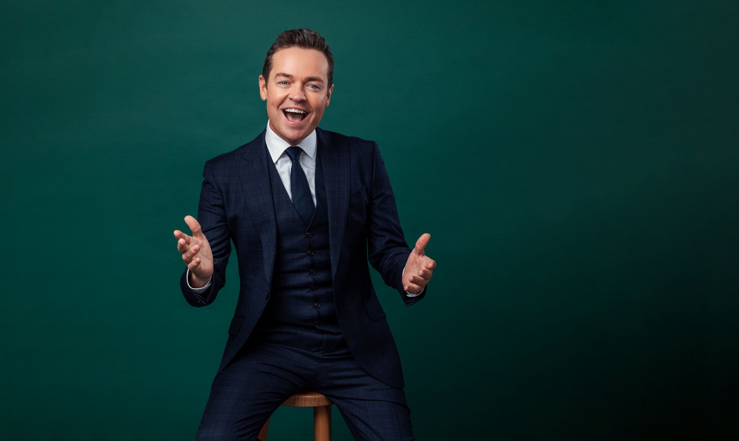 Stephen Mulhern wearing a coat while posing at the camera.