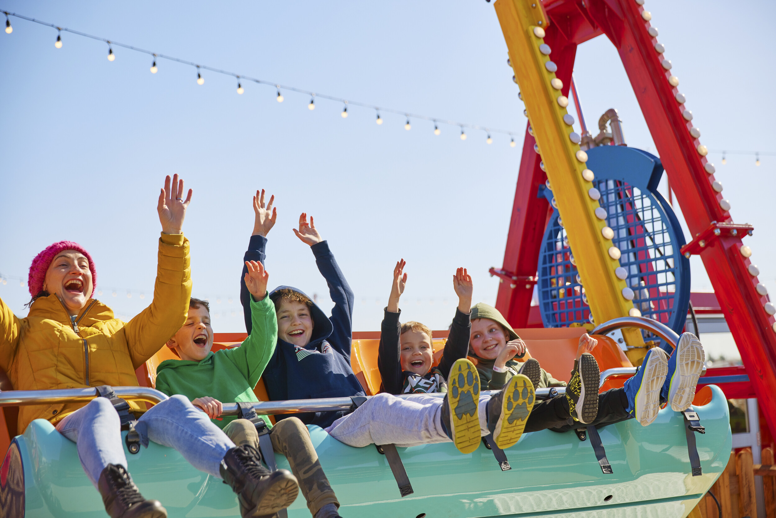 A group of children on the Super Swing ride at the fairground.