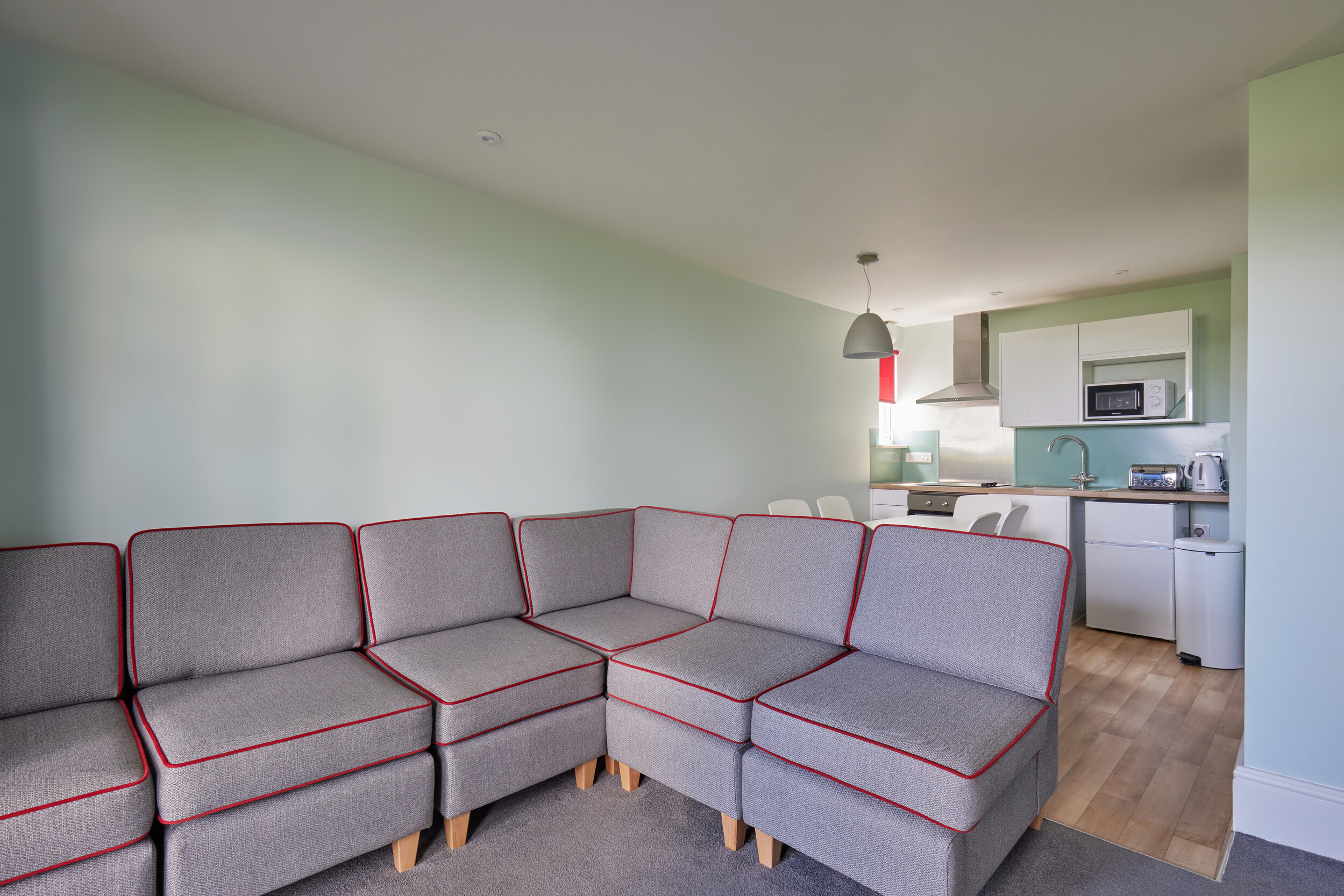 A living room with kitchen and dining area in our Comfort Apartments at Minehead.